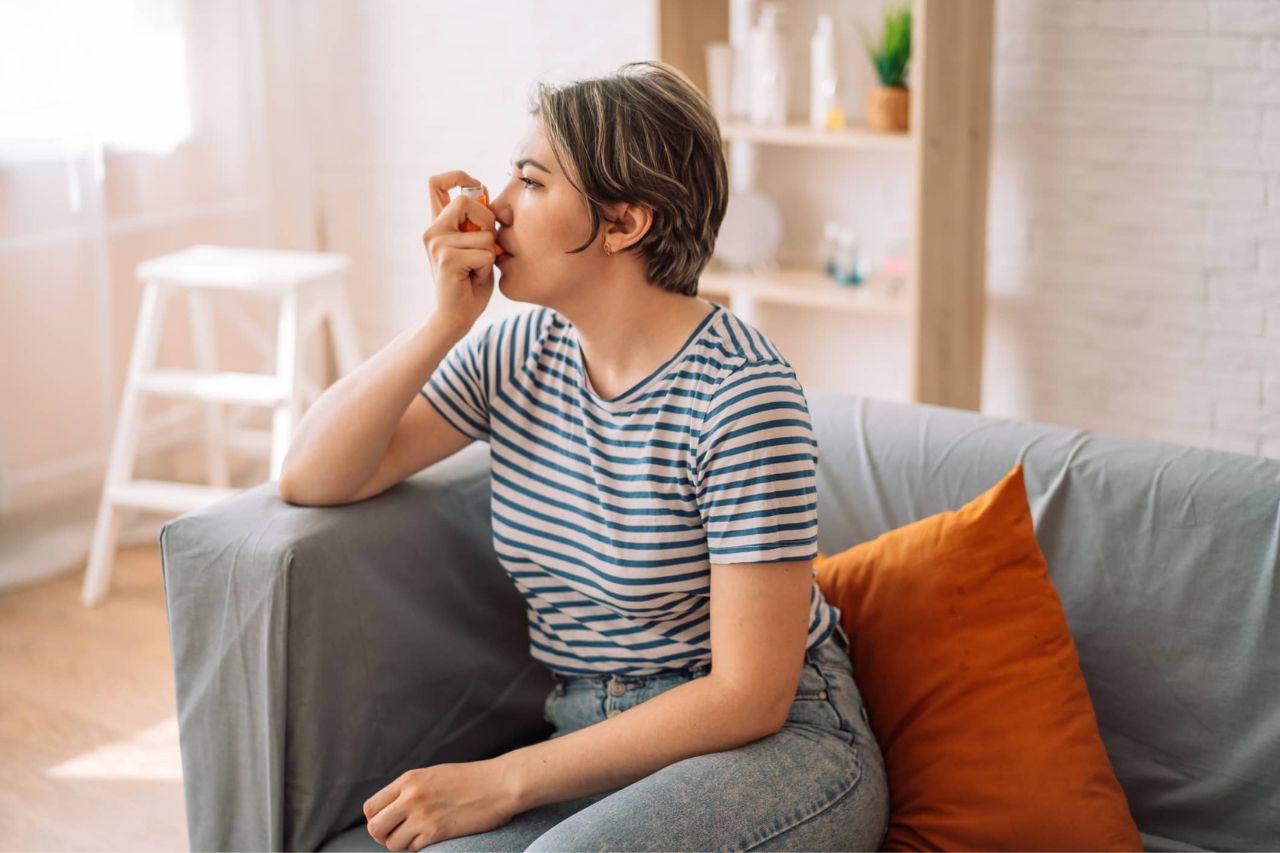 Woman using an inhaler