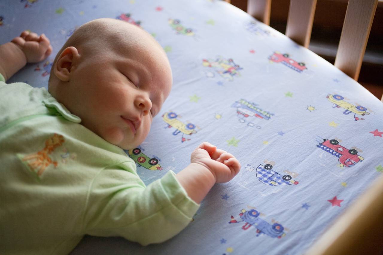 Baby peacefully sleeping in a crib