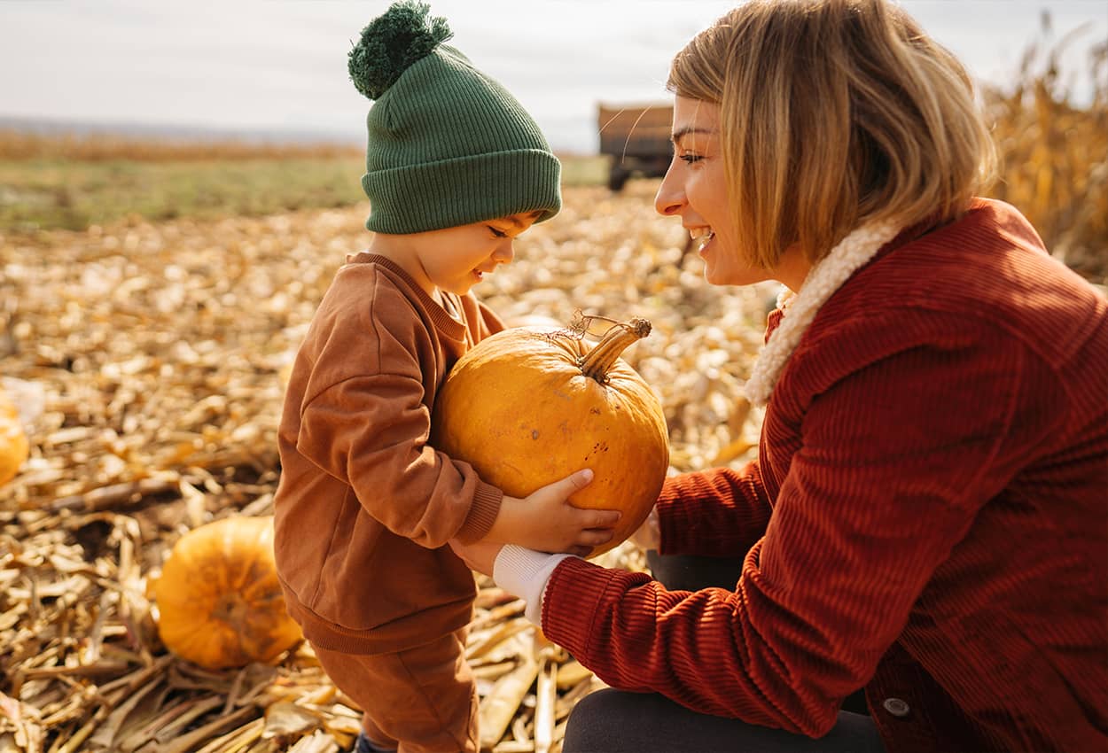 Woman and son in pumpkin patch