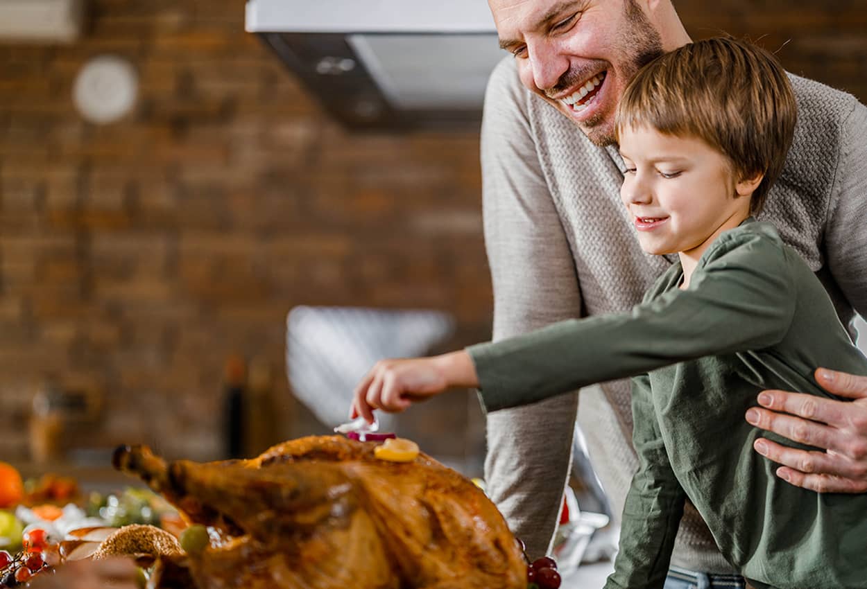 Father and Son preparing a turkey