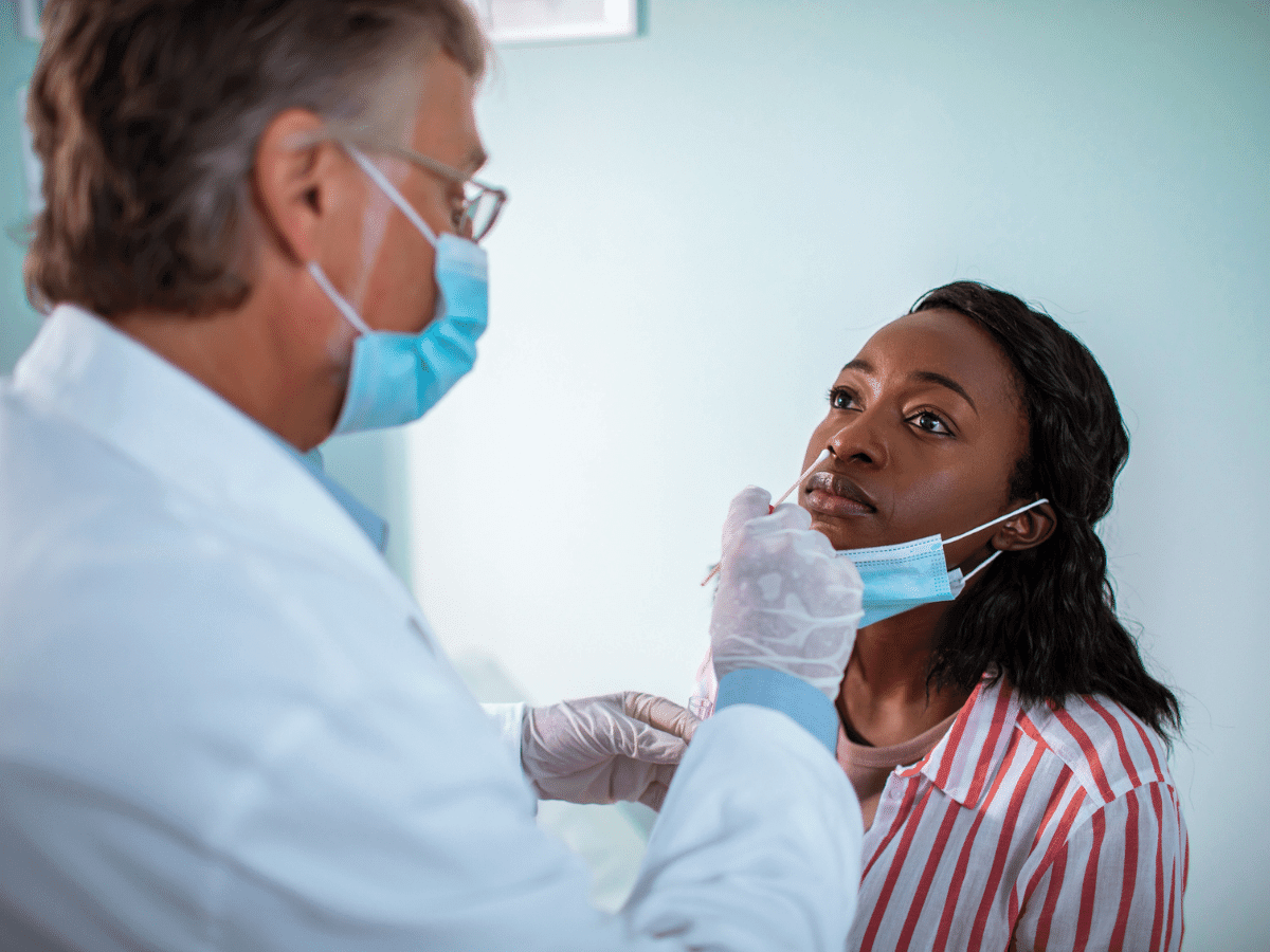 Woman receiving a COVID-19 test at her doctor's office.